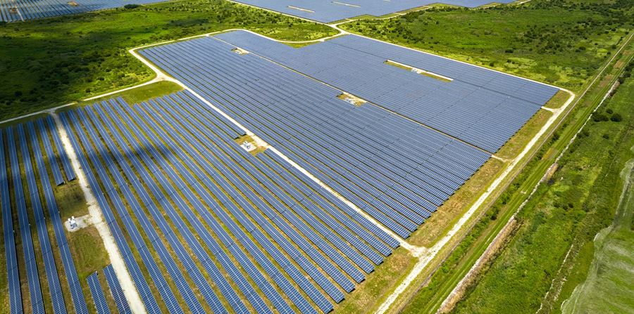aerial view of big sustainable electric power plant with many rows of solar photovoltaic panels for producing clean electrical energy renewable electricity with zero emission concept