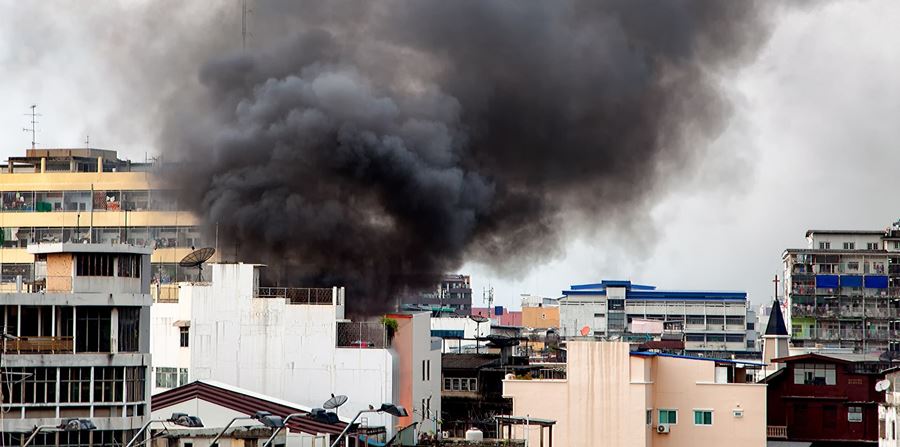Fire burning and black smoke over the commercial building.