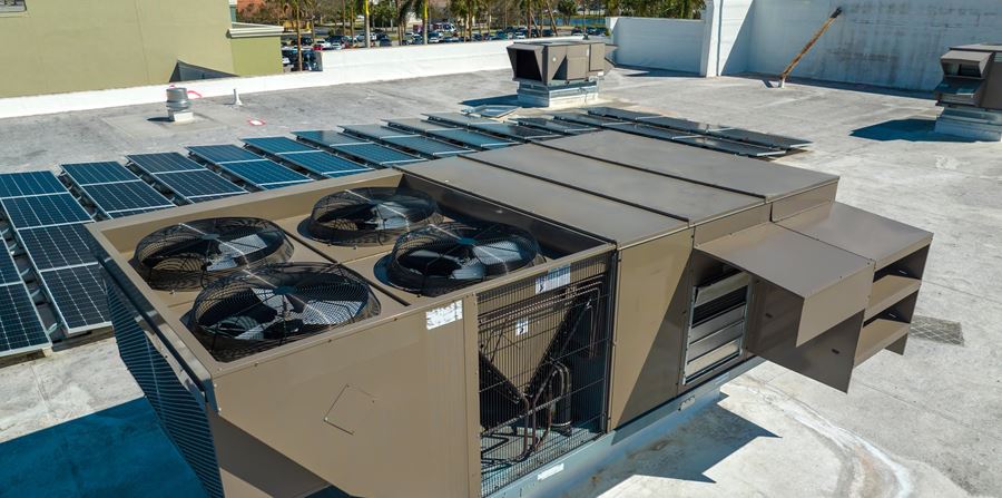 external unit of commercial air conditioning and ventilation system installed on industrial building roof exhaust vent on flat factory rooftop