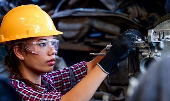 Engineer Woman Working With Machine In Factory