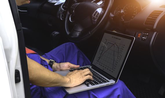 vehicle testing and safety compliance engineer working on a car